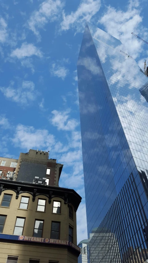 a tall building sitting next to a tall skyscr