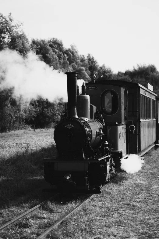 a black and white photo of a train on the tracks, a black and white photo, historically accurate, fume, built on a small, profile picture