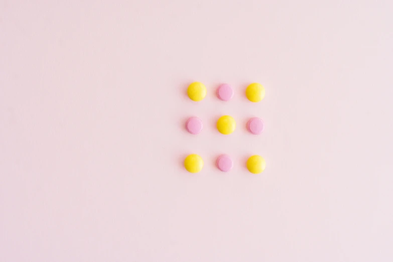 yellow and pink pills on a pink background, a minimalist painting, inspired by Damien Hirst, trending on pexels, color field, rule of thirds fibonacci, polkadots, made of candy, square shapes