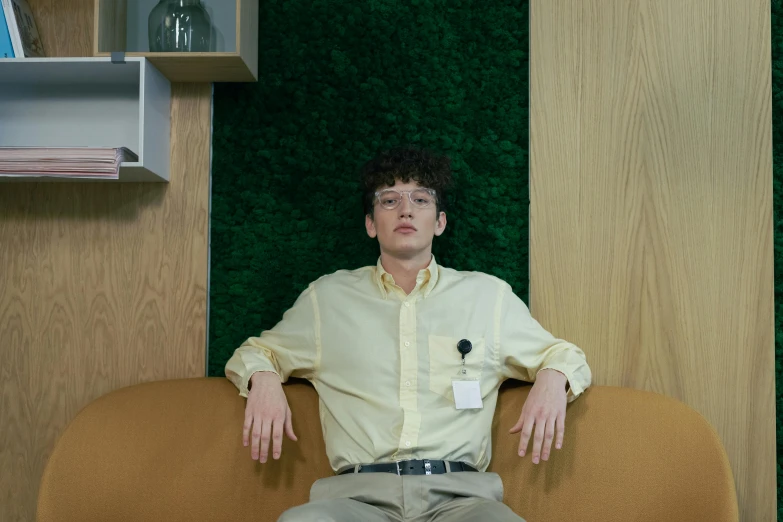 man sitting in an office with his hands on the hips