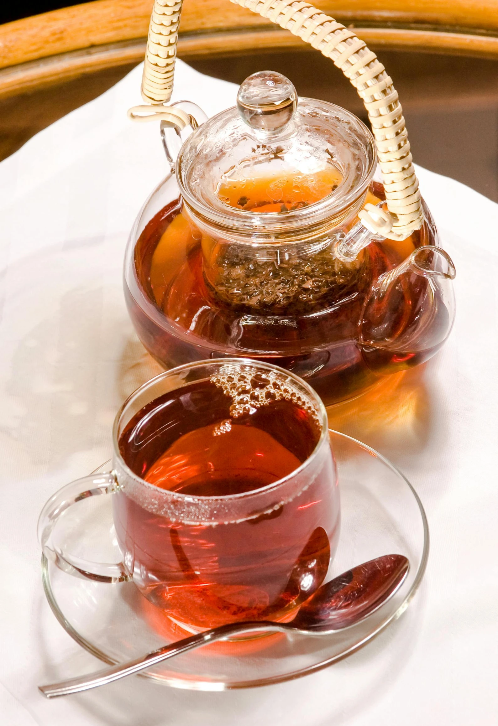a tea pot sitting on top of a table next to a cup of tea, dau-al-set, with clear glass, thumbnail, maroon, medium close shot