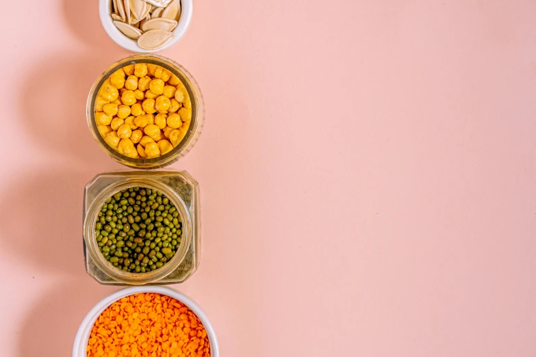 a row of bowls filled with different types of food, by Carey Morris, pexels, pink and orange, background image, beans, pasta