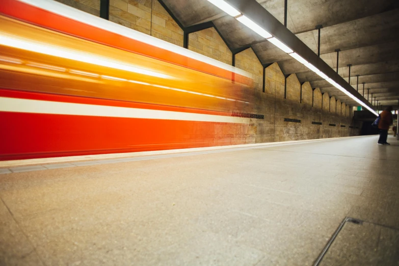 a red and white train traveling through a train station, unsplash, orange line, concrete, large scale photo, 15081959 21121991 01012000 4k