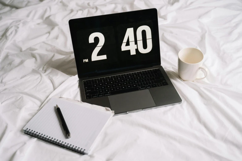 a laptop computer sitting on top of a bed next to a cup of coffee, trending on pexels, countdown, white bed, old school, numerical