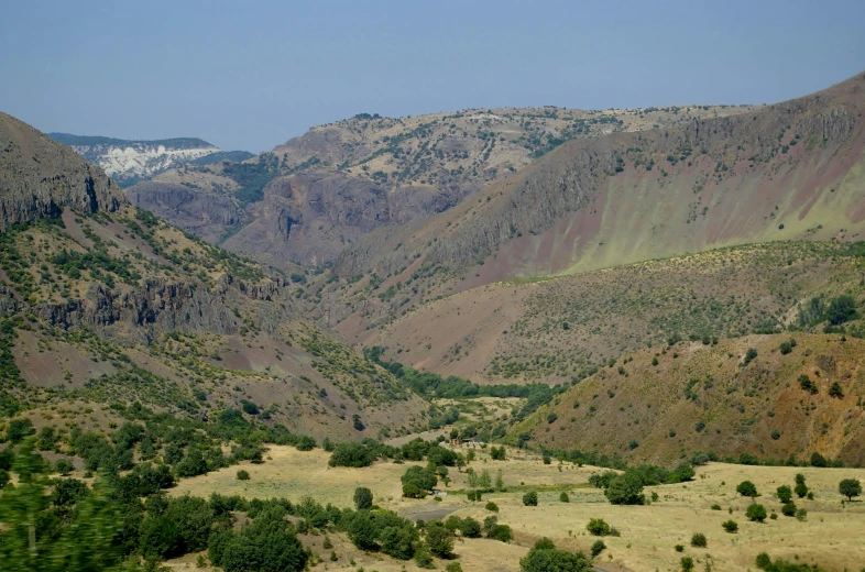 a picture of mountains with sp grass