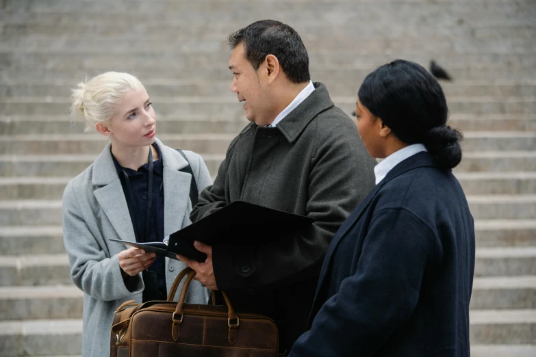 a couple of people standing next to each other, female lawyer, on location, scene from live action movie, non-binary