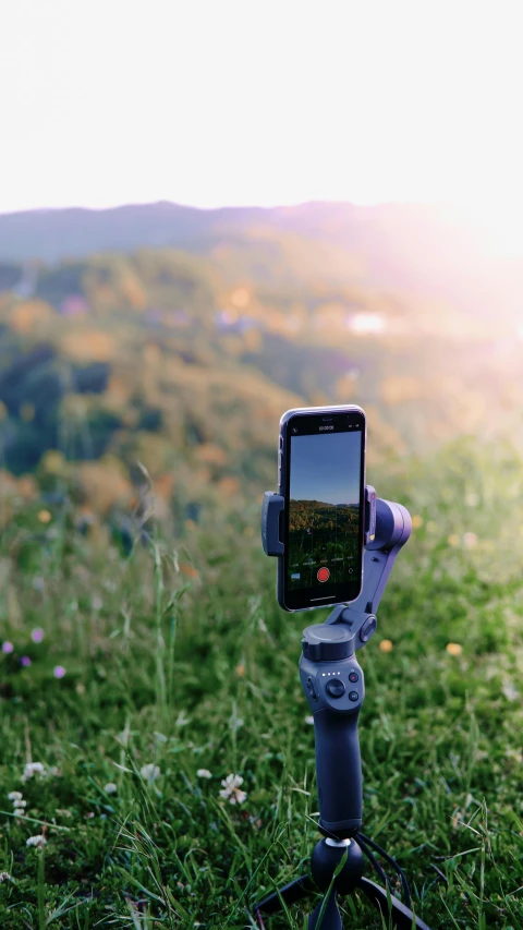 a cell phone sitting on top of a tripod, unsplash, hills, 15081959 21121991 01012000 4k, sports photo, concept photo