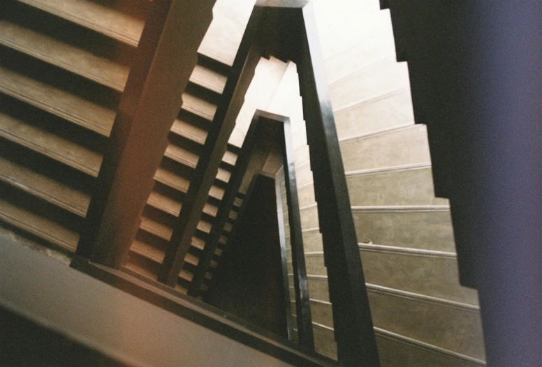 a set of stairs going up the side of a building, by Pablo Rey, brutalism, lomography, interior view, mazzoni marco, grain”