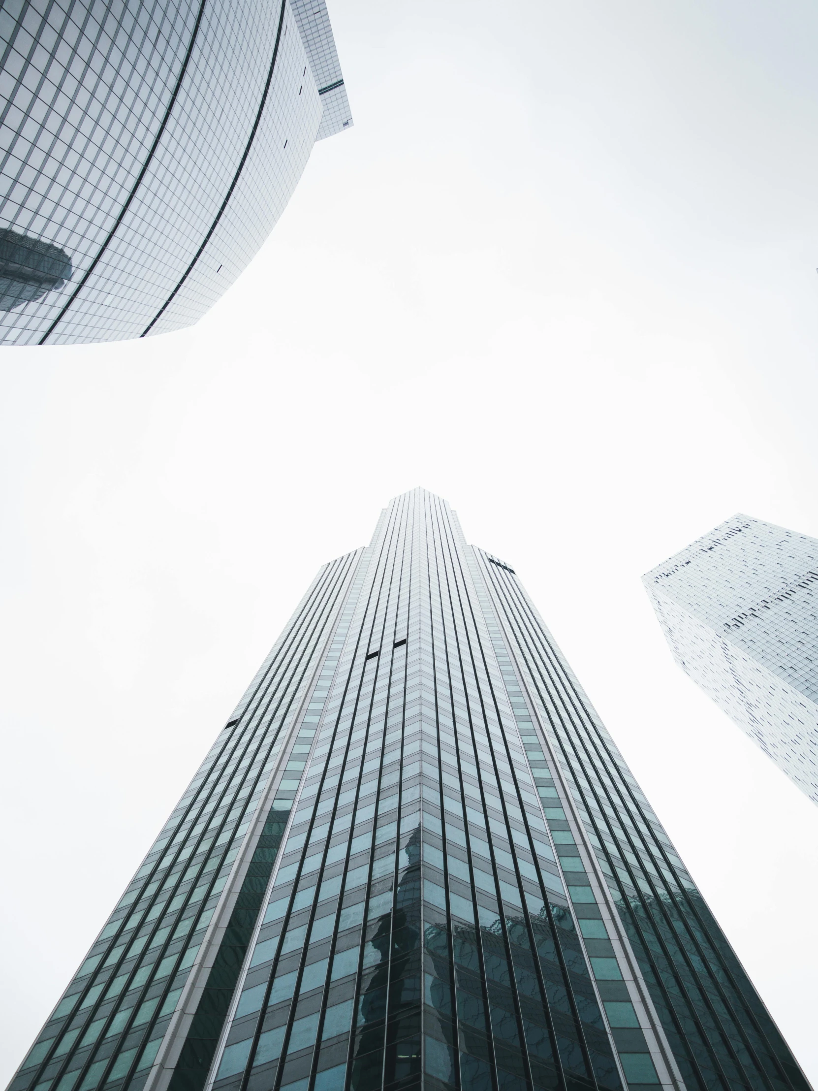 a group of tall buildings next to each other, by Adam Rex, pexels contest winner, high key detailed, three towers, grey, glass ceilings