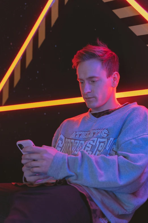 a man sitting in a chair using a cell phone, trending on reddit, holography, caspar david, standing in a starbase bar, neon lights in the background, headshot profile picture