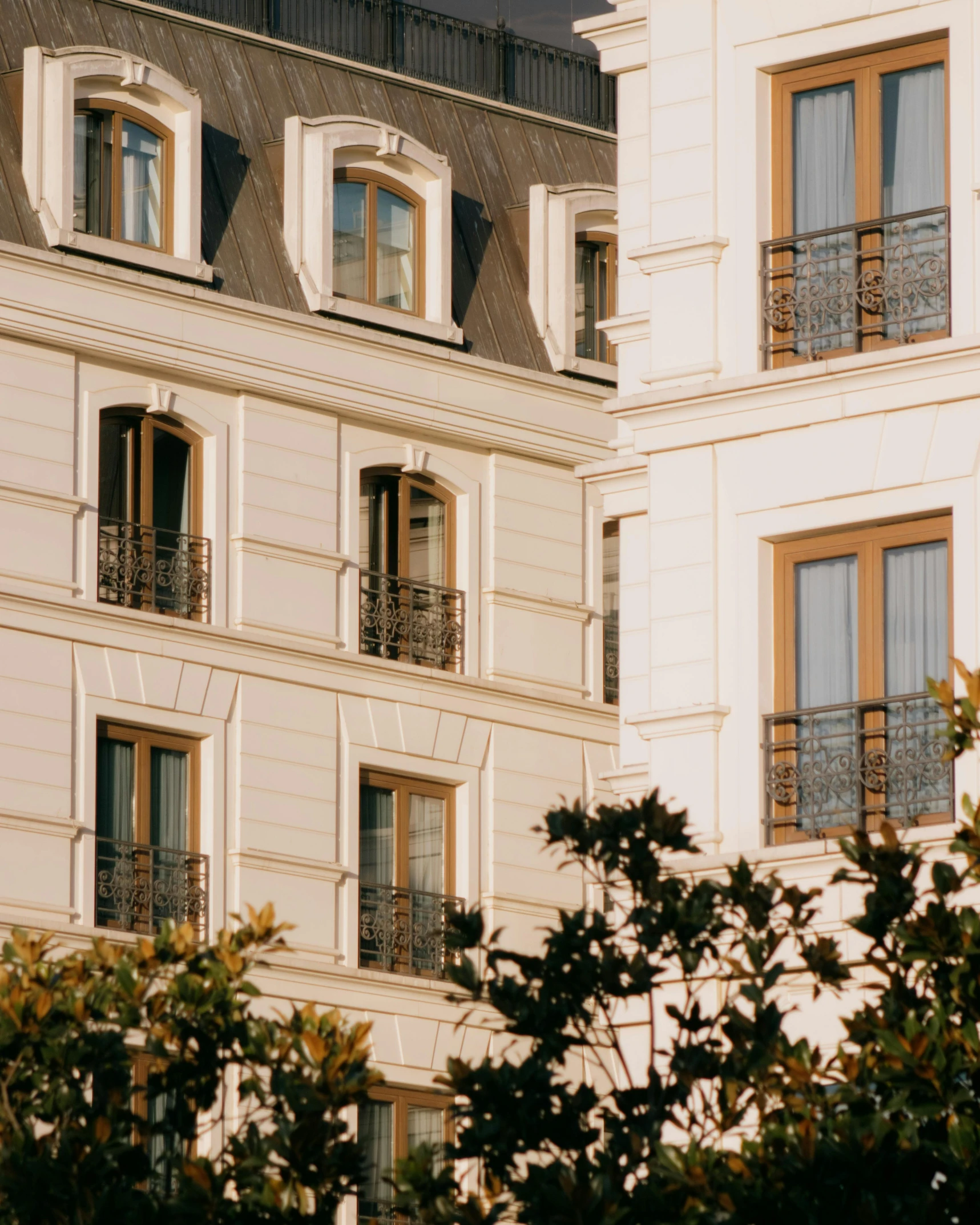 a white building with windows and balconies in front