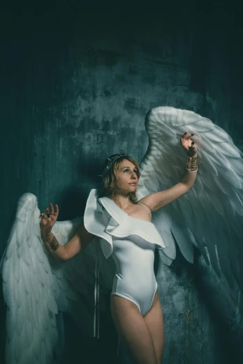 a woman in a white bodysuit with angel wings, inspired by David LaChapelle, pexels contest winner, renaissance, beth cavener, portrait photo, stormy, full body with costume