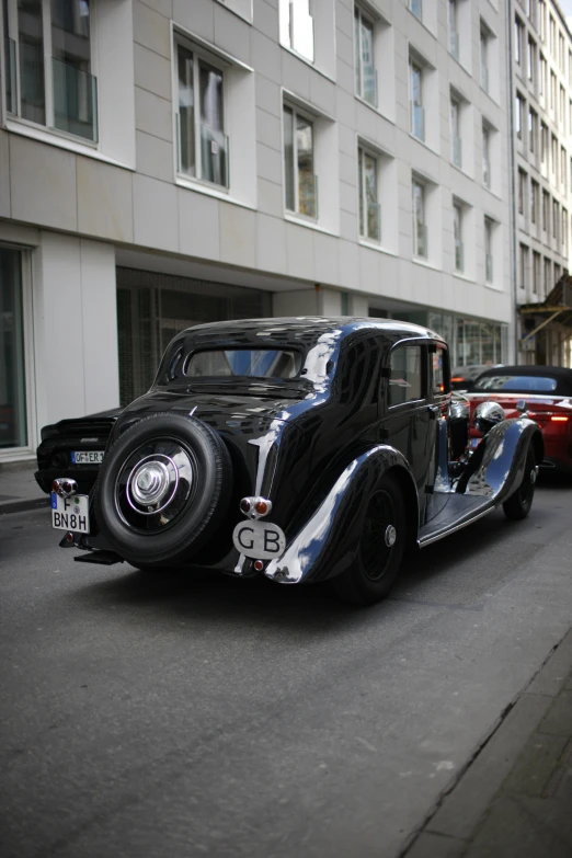 this is a black  rod type car in a street