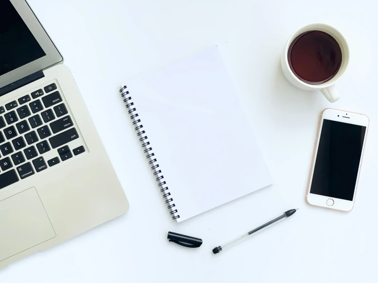 an open laptop computer sitting next to a cup of coffee, pexels, whiteboards, background image, 9 9 designs, 2000s photo