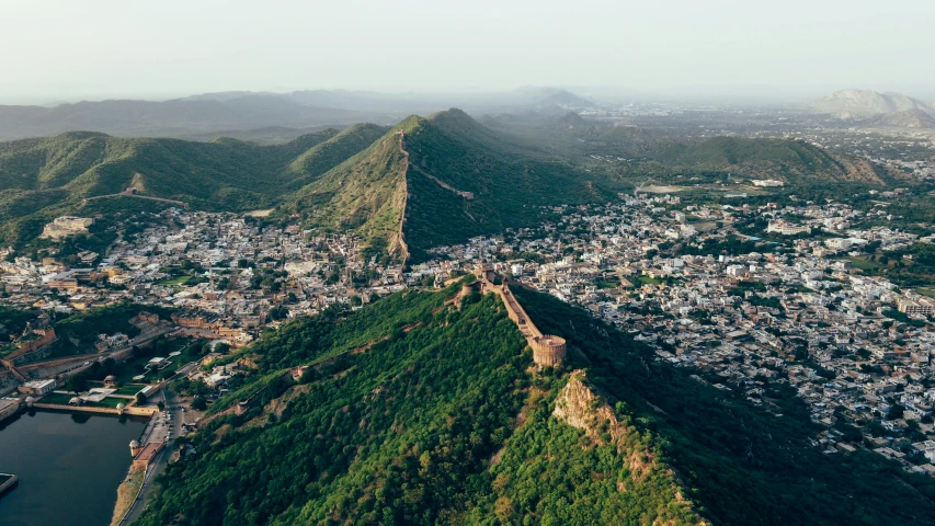 an aerial view shows mountains surrounding a city