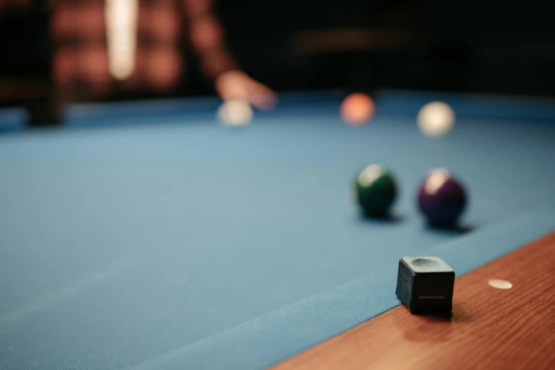 several pool balls sit on top of the table