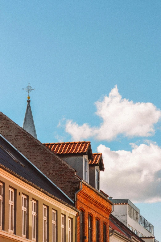 a clock that is on the side of a building, by Jan Tengnagel, pexels contest winner, baroque, simple gable roofs, sunny day with clear sky, viewed from afar, color corrected