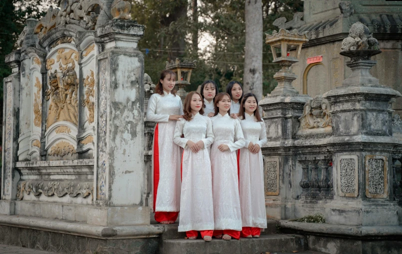 a group of women standing next to each other, an album cover, inspired by Ruth Jên, pexels contest winner, happening, vietnamese temple scene, wearing a formal dress, white sleeves, 15081959 21121991 01012000 4k