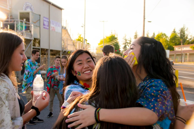 a group of young women standing next to each other, a picture, pexels contest winner, happening, wearing a tie-dye shirt, hugs, high school, avatar image