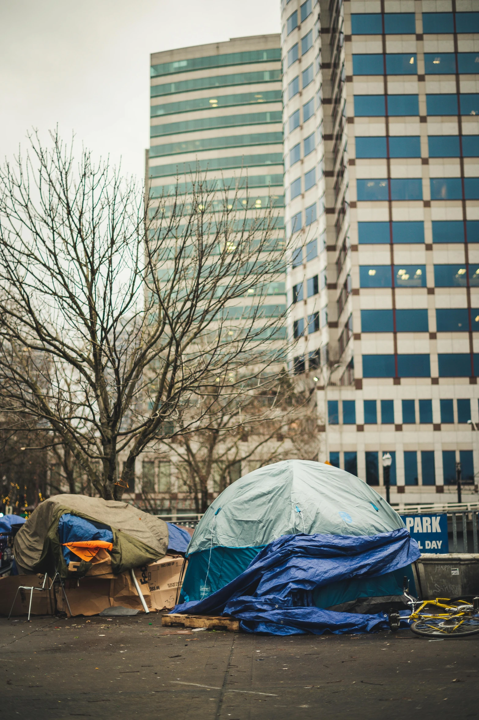 a group of tents sitting on the side of a road, a photo, by Jason Felix, trending on unsplash, capitol hill, big poor building, square, “pig