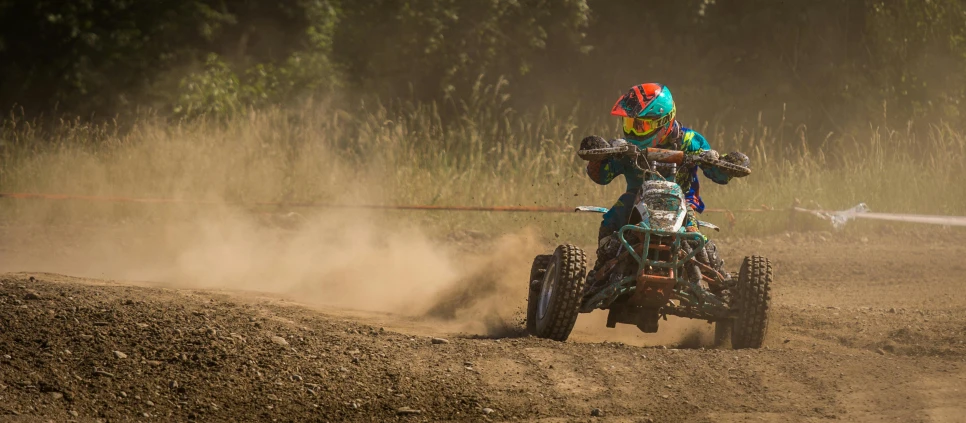 a man riding a dirt bike on top of dirt