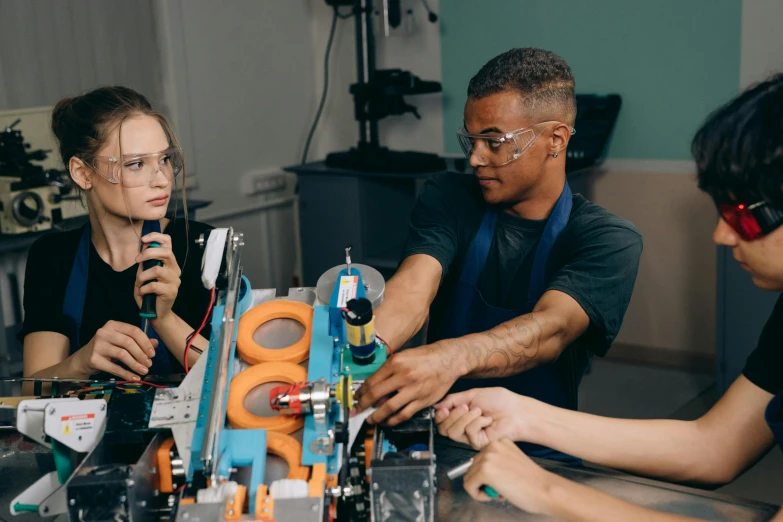 a group of people sitting around a table, mechanical, profile image, school class, thumbnail