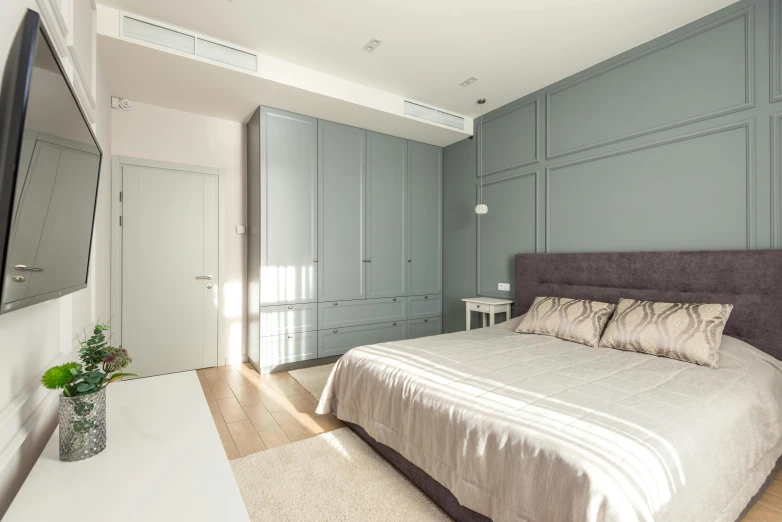 a clean bedroom with grey painted walls and gray storage