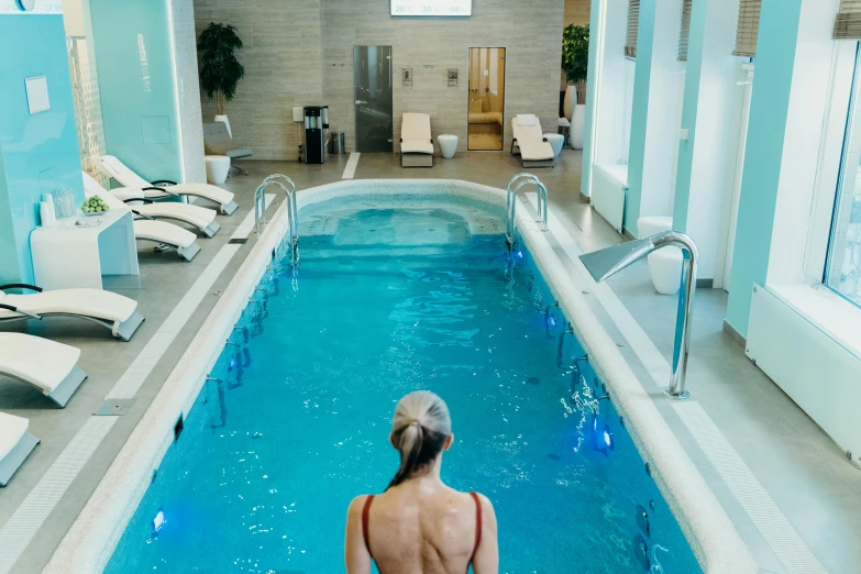 a person sitting in a pool with a swimming board