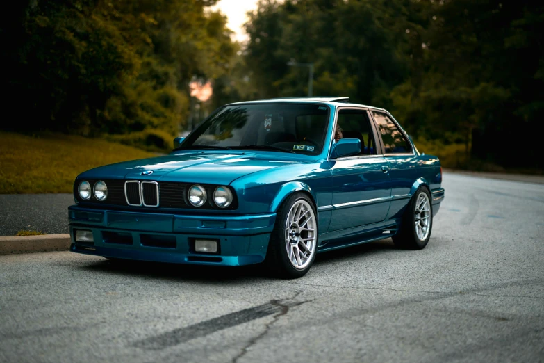 a blue car parked on the side of a road, by Drew Tucker, unsplash contest winner, renaissance, bmw e 3 0, 2 0 % pearlescent detailing, smooth in 8k, white and teal metallic accents