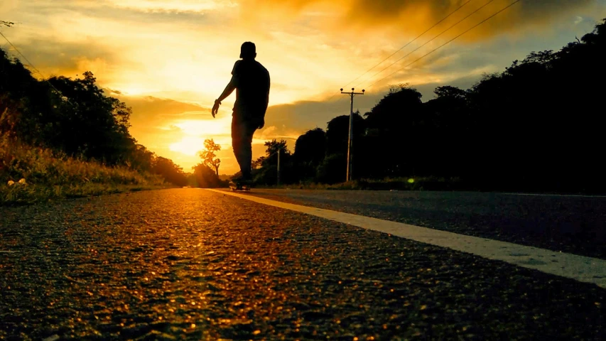 a person riding a skateboard down a road at sunset, happening, profile image, thumbnail, ((sunset)), fan favorite