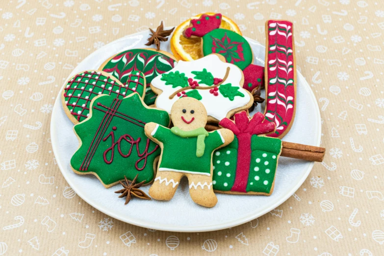 a plate of decorated christmas cookies on a table, by Jeka Kemp, pexels, naive art, green and brown clothes, positive mood, gifts, ginger