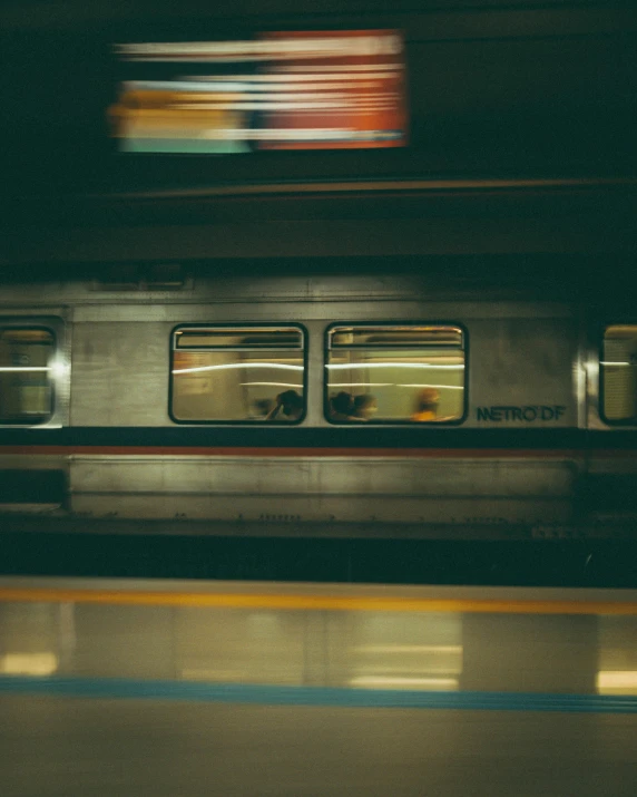 a train traveling down a train track next to a platform, by Carey Morris, underexposed, lgbtq, square lines, panoramic shot