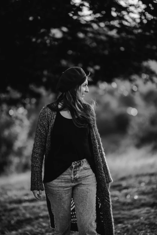 a woman standing in the middle of a park