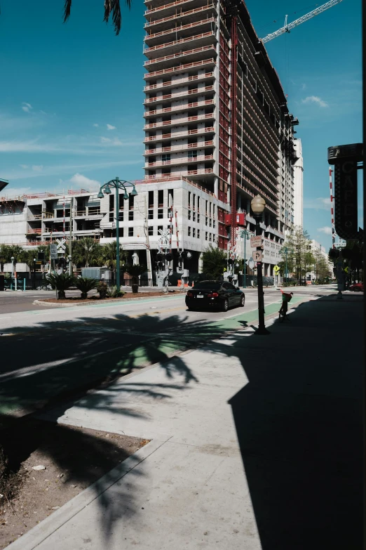 a city street with a traffic light and cars parked next to a building