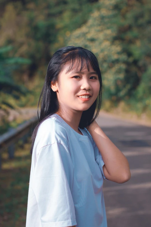 a woman standing on the side of a road, inspired by Ma Yuanyu, pexels contest winner, realism, wearing a light blue shirt, headshot profile picture, young cute wan asian face, 1996)