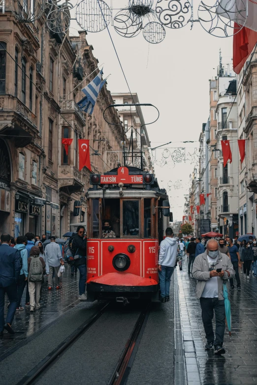 a red trolley car with several people on it