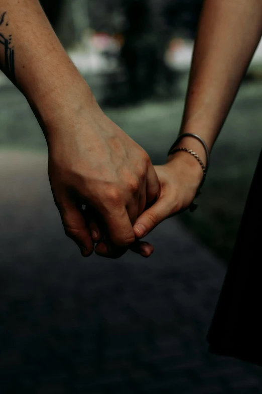 a couple holding hands on the street