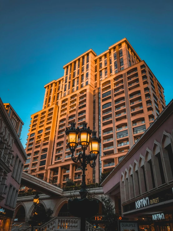 a streetlight sits on a city street near a tall building