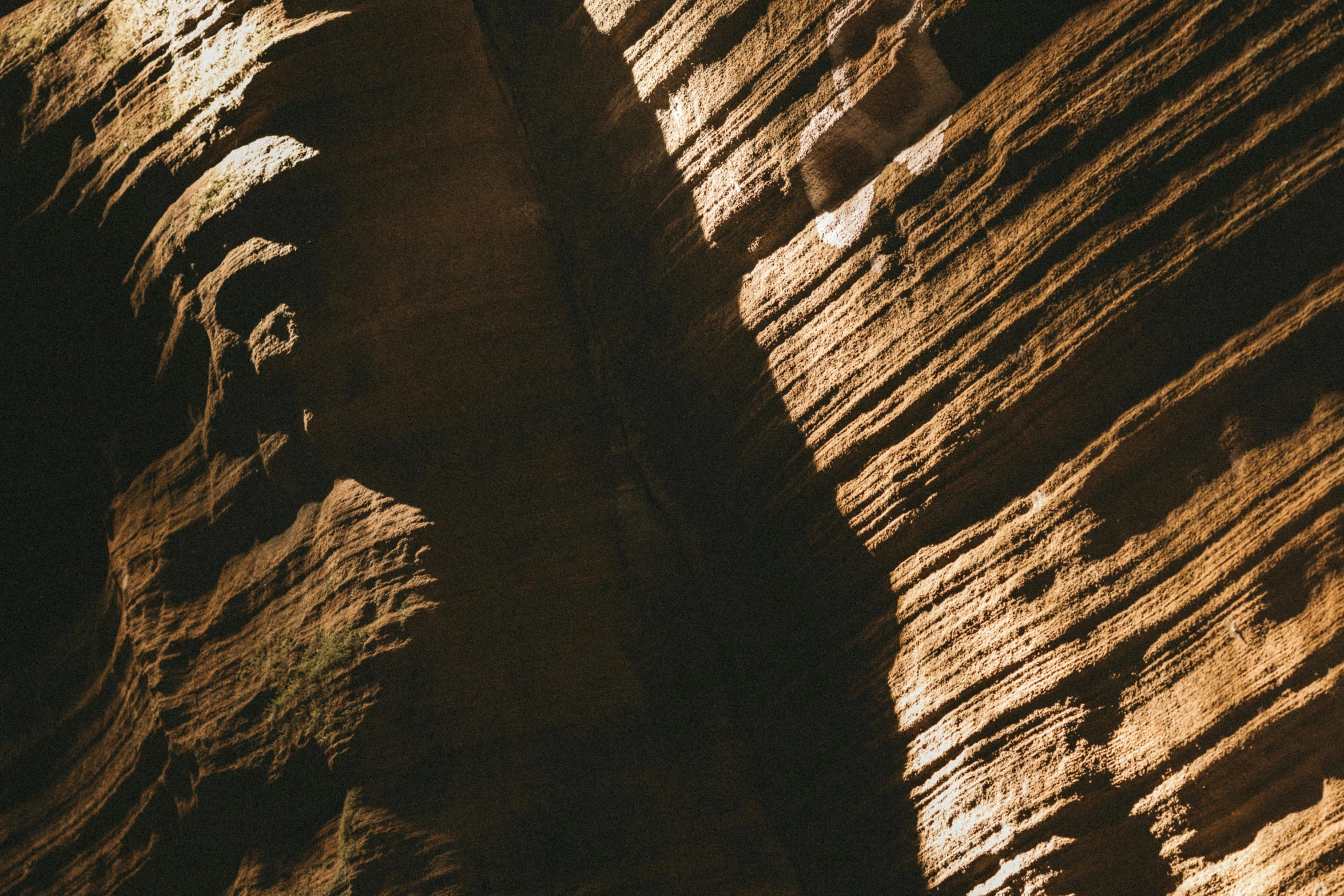 a man riding a surfboard on top of a wave, an album cover, pexels contest winner, australian tonalism, found in a cave made of clay, striations, grand canyon | golden hour, ocher details