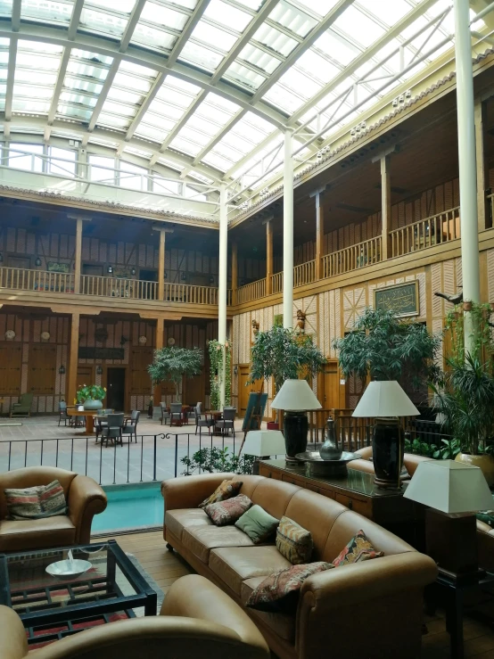 inside of a large building with many tables and couches