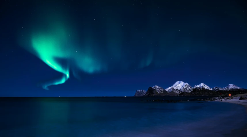 the aurora bore is illuminated against a blue night sky