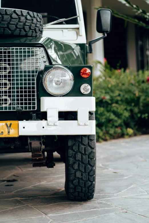 a green land rover parked in front of a house, a portrait, by Sven Erixson, unsplash, low detail, sri lanka, white mechanical details, square