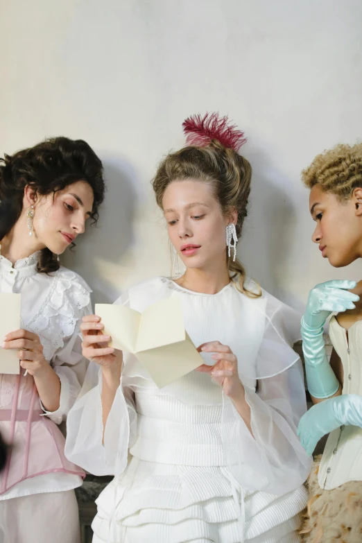 a group of women standing next to each other, inspired by Jean-Étienne Liotard, trending on unsplash, rococo, writing a letter, perfectly lit. movie still, white gloves, elaborate hair worn up