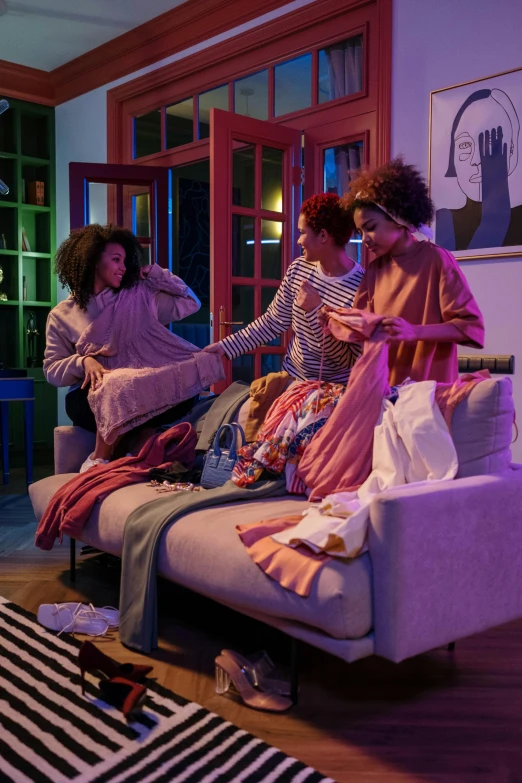 a group of women sitting on top of a couch in a living room, happening, cool night color, hue, tech robes, messy clothes