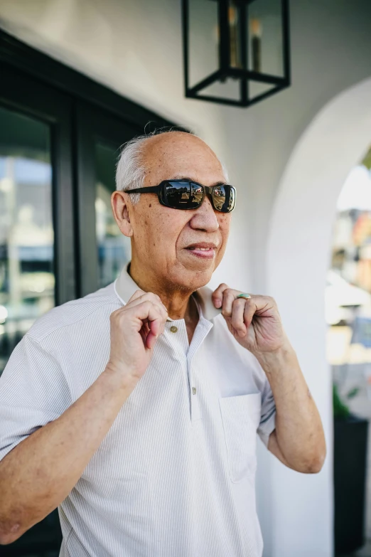 an old man in sunglasses wearing some sort of shirt