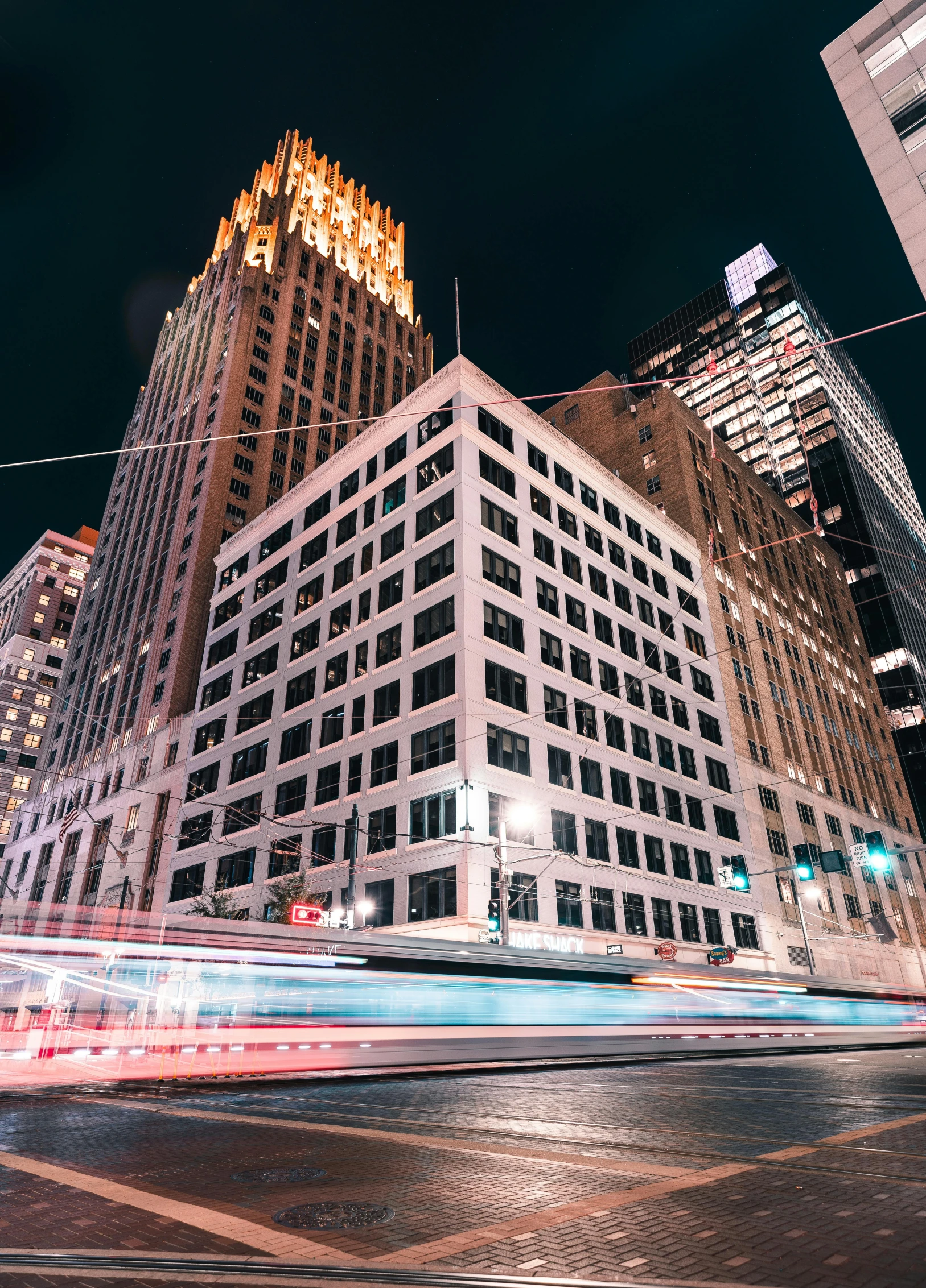 a tall building with lights all over it at night