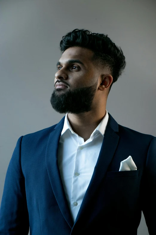 a man in a blue suit and white shirt, pexels contest winner, hurufiyya, at a fashion shoot, profile image, rj palmer, beard