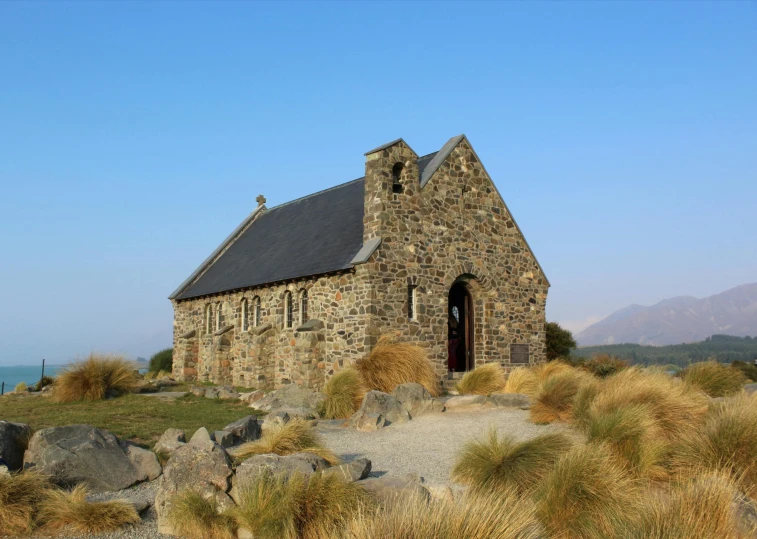 a small stone church nestled in the hills