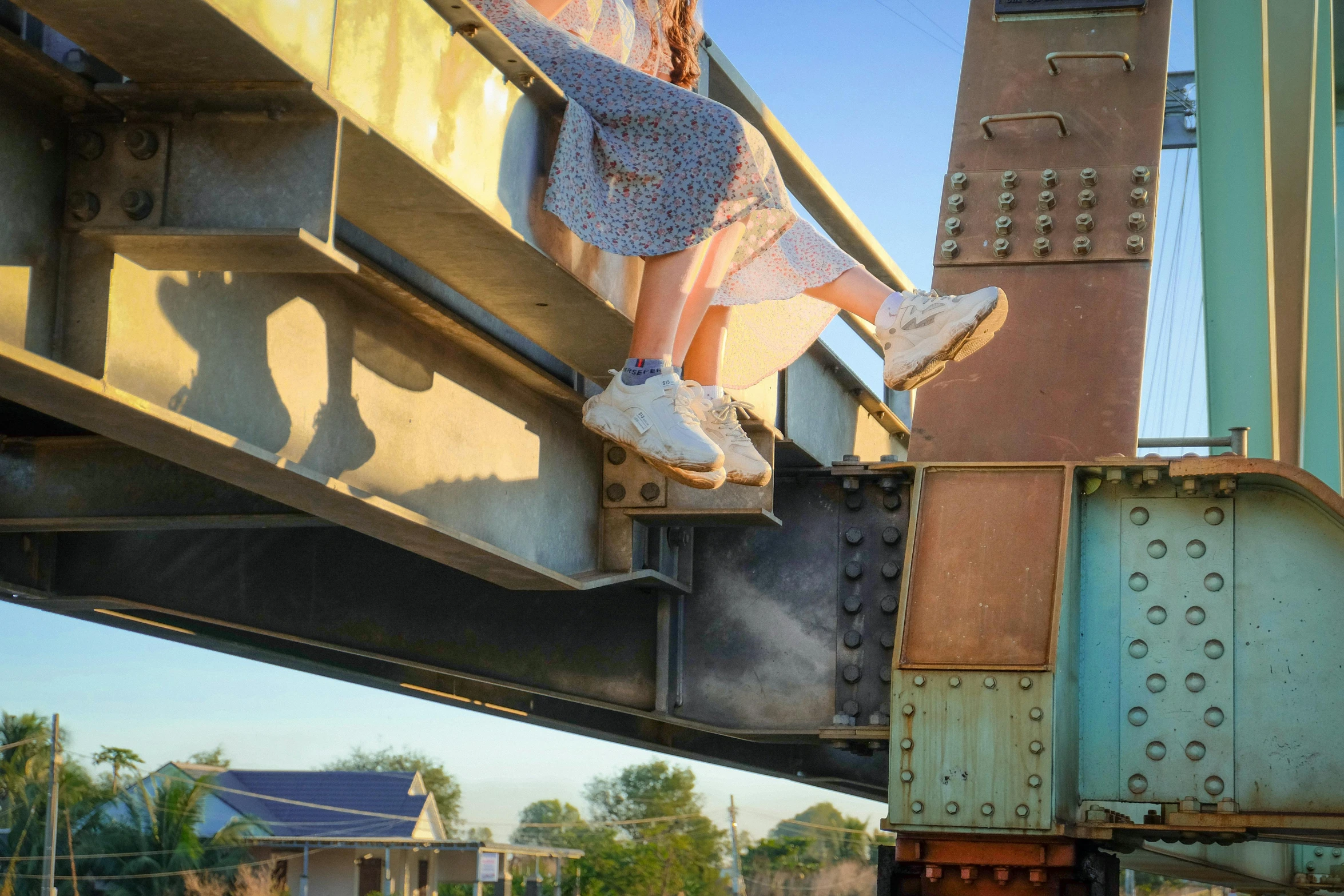 a woman sitting on top of a train bridge, giant kicking foot, underbody, ash thorp, rusty