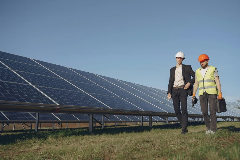 two men standing in front of solar panels, by Carey Morris, pexels contest winner, worksafe. cinematic, cgi 8k, on ground, man and woman walking together